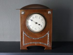 A E Jones copper and silver clock