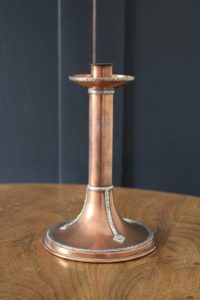 A E Jones copper and silver candlestick