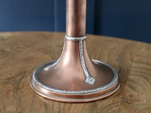 A E Jones copper and silver candlestick